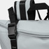 A grey cooler toting bag with black straps and a buckle, featuring a zippered compartment and handles.
