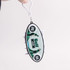 A Golf Tee Set with a black and white oval design, featuring four white golf tees and a logo. It has a keychain attachment.