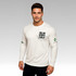 A man in a white long-sleeved crew neck shirt with a logo and text design on the front and sleeve.