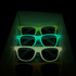 Glow in the dark sunglasses in green shades, stacked inside a display box. The sunglasses emit a soft glow in the dark.