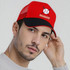 A red peak cap with a black brim and a mesh back, featuring a logo on the front.