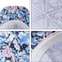 A floral-patterned 6 panel custom cap with a button, featuring shades of blue, pink, and white. It has a logo.