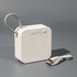 A white portable Bluetooth speaker with a textured loop and a USB charging cable.