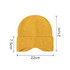 A yellow earflap beanie with ribbed texture, measuring 21cm in height and 22cm in width.