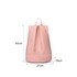 A pink backpack with a handle and two compartments, featuring a zipper on the bottom section.