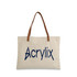 A canvas bag in beige with brown leather straps and a logo in navy blue.