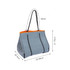 A large grey neoprene beach tote bag with orange accents and black and white handles, featuring mesh panels.