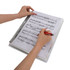 A loose-leaf folder with sheet music is being held and written on with a red pen. The folder has a metallic spiral binding.