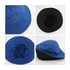 A blue and black custom cotton bucket hat featuring a wide brim and a soft interior. It has a logo on the exterior.