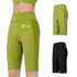 High-waisted elastic yoga leggings in green and black, featuring a branding logo on the green pair.