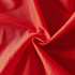 A close-up of a red polyester mesh fabric, featuring a breathable, textured surface. The fabric is lightweight and soft.
