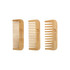 Three eco-friendly bamboo combs in light brown, featuring a logo on each comb.