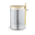 A clear glass container with a bamboo lid and spoon, designed for storing overnight oats.