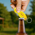 A drink bottle being opened with a yellow custom shape trolley coin keyring bottle opener, featuring a logo.