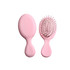 A pink mini paddle brush with a smooth handle and rounded bristles, featuring a simple design.