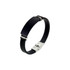 A black colour engraved bracelet featuring a sleek design and a silver clasp, with metallic accents.