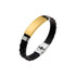 A bracelet featuring a gold stainless steel buckle latch and a black rubber band, with a shiny finish and a logo.