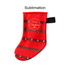 A red Christmas stocking featuring festive patterns, trees, and a decorative label, with a hanging loop.