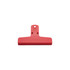 A red plastic clip with a hole for hanging and a flat grip surface. It features a logo on the front.