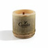 A bamboo candle in a natural wood holder featuring a wooden wick, with a logo on the side.