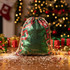 A green sequin drawstring bag with red and white accents, placed against a festive background with Christmas decorations.