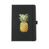 A black notebook featuring a pineapple illustration on the front cover. It has a strap closure and a ribbon marker.
