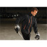 Men's Axis Thermal Jacket in black with orange accents, worn by a person on an ice rink, holding a hockey stick.