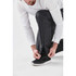 Men's Olympia Rain Pant in black, featuring a model adjusting the pant hem and a discreet logo.