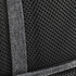 Black mesh fabric detail with stitching from a backpack, featuring a textured pattern and reinforcement tape.
