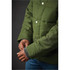 A green thermal jacket with a quilted design and silver snaps, featuring a textured cuff.