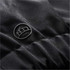 A close-up of a black fabric detail featuring a small logo on a Men's Polar HD 3-In-1 Jacket.
