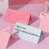 A collection of decorative, colourful notepads in pink and silver with playful designs and motivational text.