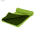 A lime green cooling towel rolled partially open, featuring a textured exterior and a smooth inner surface.