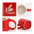 A red ceramic mug with a glossy finish, featuring a handle and an inner cream colour, along with a logo.