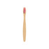 A small bamboo toothbrush with a pink bristle head and a smooth bamboo handle. It has a simple logo on the base.