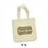 A natural cotton tote bag featuring a simple design and an emblem. It has two sturdy handles for easy carrying.