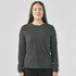 A long-sleeved women's tee in a dark green colour, featuring a logo and a relaxed fit.