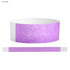 A lavender Tyvek adult wristband, 25mm wide, featuring a smooth texture and a secure fastening.