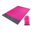 A medium pouch picnic blanket in vibrant pink with a black bottom, accompanied by a matching storage pouch.