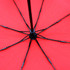 A red umbrella with a black frame and ribs, featuring a central handle and support structure.