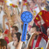 A blue Sponge Ball Cheerstick featuring a soccer ball design with a handle, set against a cheering crowd backdrop.