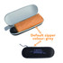 A mini folding umbrella in an orange pouch, stored in a grey case with a logo.