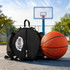 A black ball backpack sits next to an orange basketball on a court, with a basketball hoop in the background.