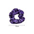 A purple hair scrunchie with a pattern of skulls, bats, and stars. It has a diameter of 10 cm and features a logo.