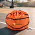 A round orange drawstring backpack designed with a basketball pattern and featuring a logo.
