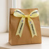 A brown gift bag adorned with a yellow satin ribbon featuring a logo and text.