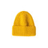 A twisted cable cuffed beanie in vibrant yellow with a textured knit design and a folded cuff.