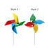 A colourful pinwheel featuring red, blue, yellow, and green blades, mounted on a white stick.