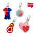 Four custom shape reflective keychains in various colours: a jersey, a circle, a lightbulb, and pink hearts, each with a clip.