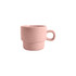 A stackable ceramic mug in soft pink with a handle and a two-layer design. Features a logo on the side.